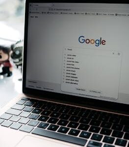 A close-up shot of a laptop displaying a Google search page with related searches visible.
